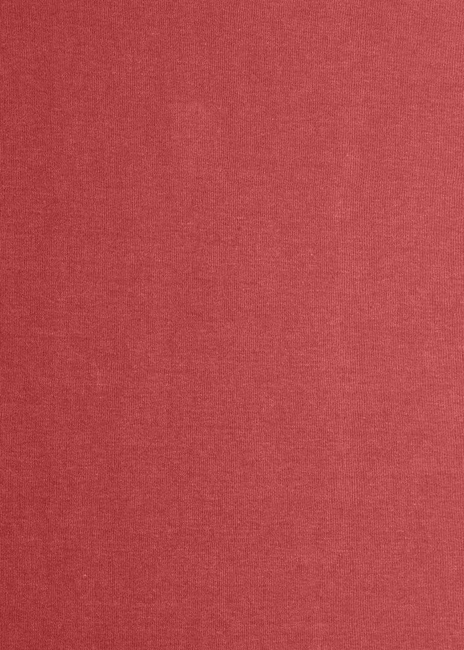 Cabecero tapizado en tela burdeos.