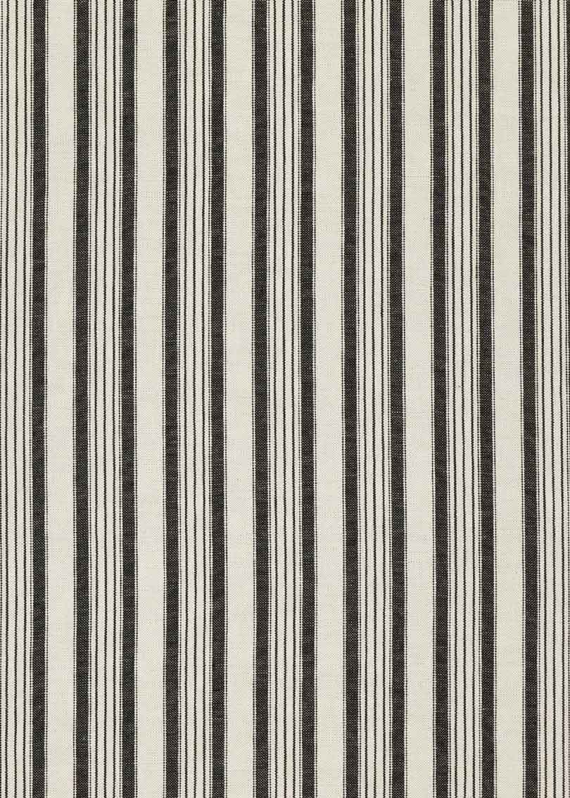 Cabecero individual tapizado en tela estampada de cuadros de rayas.