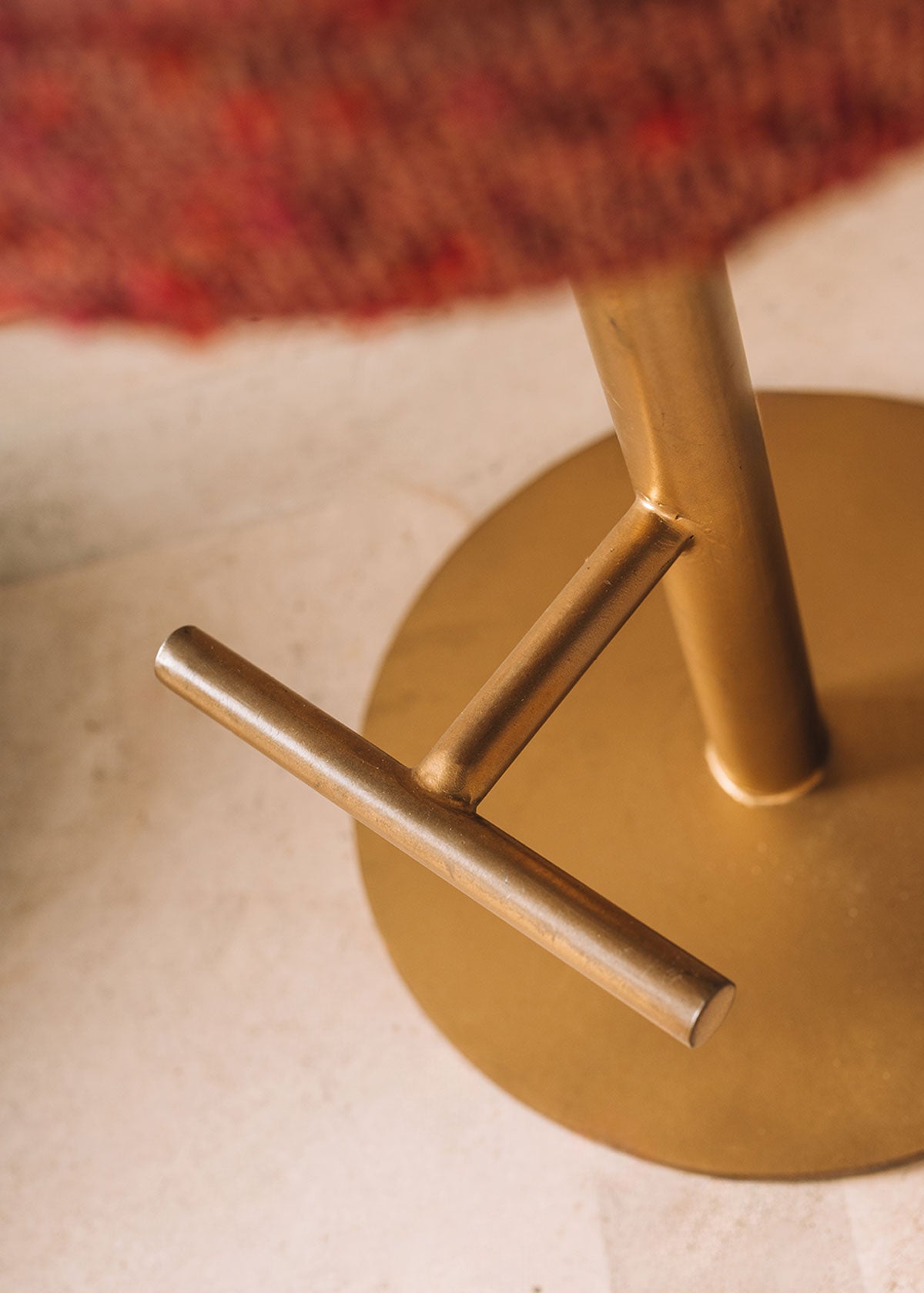 Taburete tapizado con estructura de hierro y reposapiés