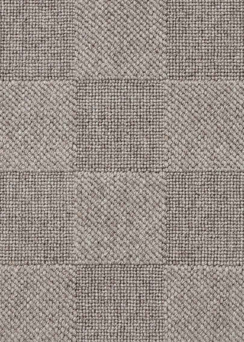 Alfombra fabricada con lana de color gris en telar wilton con superficie en bucle con saltillo.