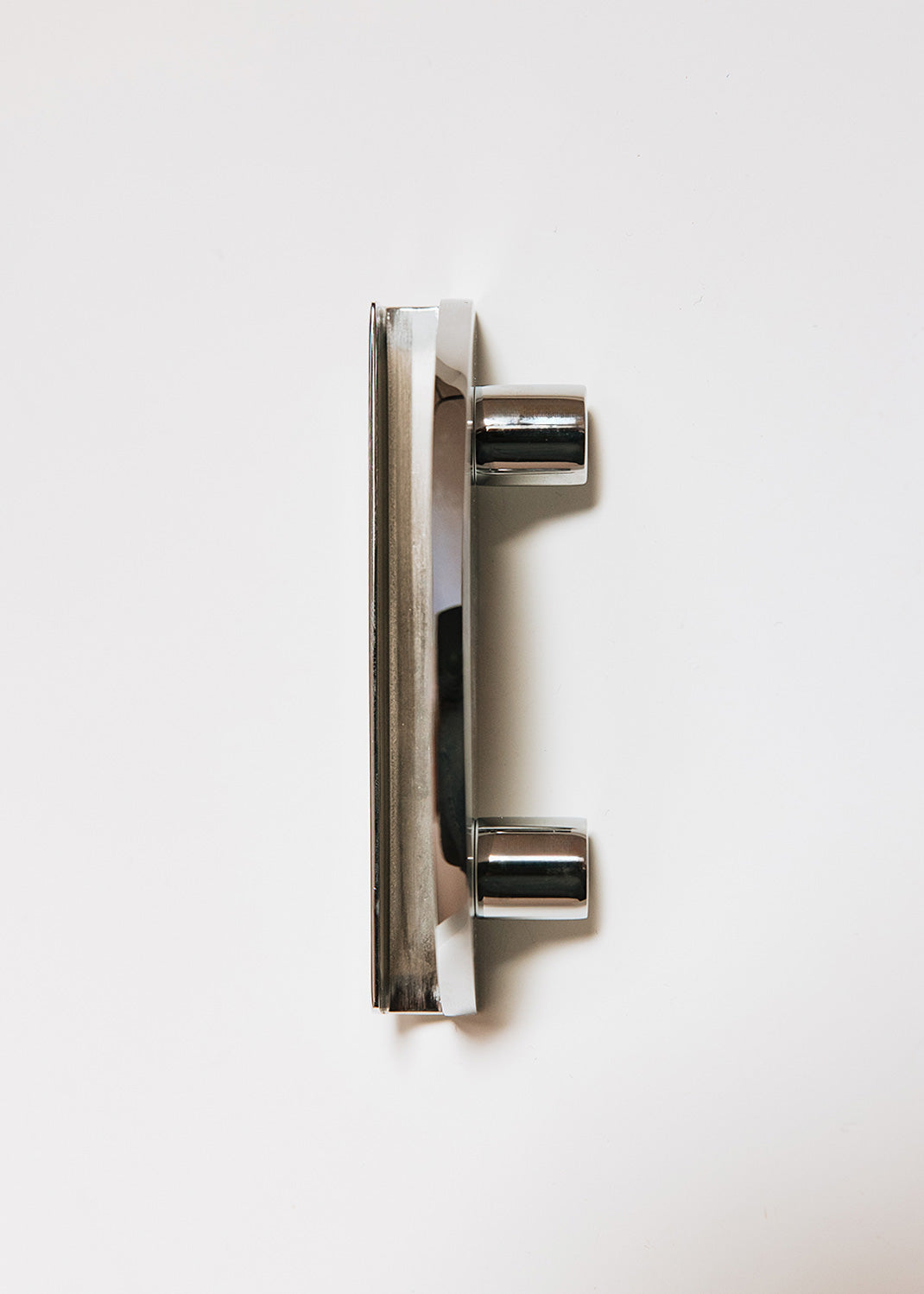 Crescent-shaped metal handle wrapped in ostrich leg leather