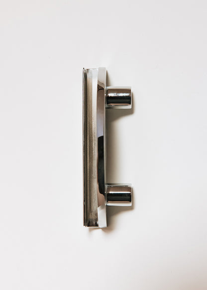 Crescent-shaped metal handle wrapped in ostrich leg leather