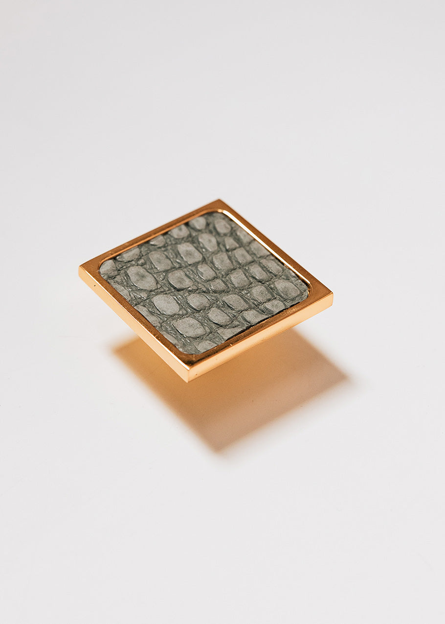 Square metal handle covered in crocodile leather