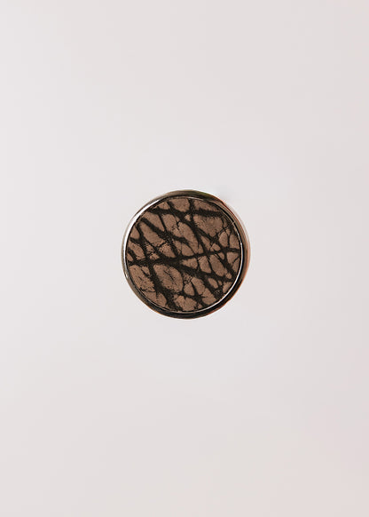 Round metal handle covered in bison leather
